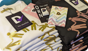 Cropped photo of piles of t-shirts.